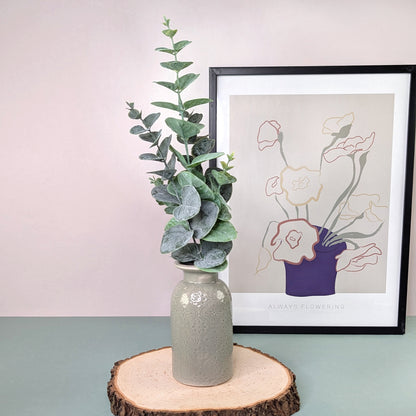 Zweig dekorativ in einer Keramikvase arrangiert