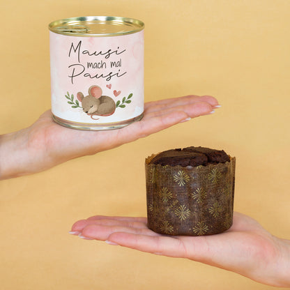 Kompakter Dosenkuchen „Mausi mach mal Pausi“ auf einer Hand neben ausgepacktem Brownie zur Größenansicht
