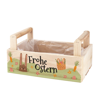 Oster Geschenkkorb aus Holz mit zwei Griffen und Aufdruck „Frohe Ostern“ mit Pflanze und Weinflasche