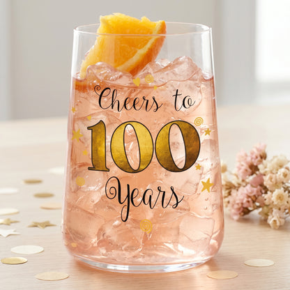 Trinkglas zum 100. Geburtstag mit rosa Getränk, Eiswürfeln und Orangenscheibe