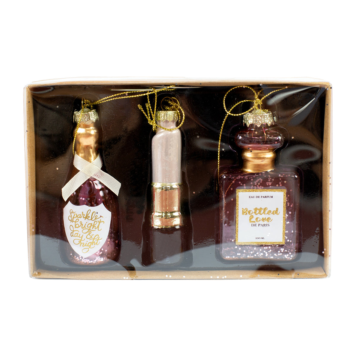 Verpacktes 3er Set Glas Christbaumschmuck mit Parfümflakon, Lippenstift und Sektflasche auf weißem Hintergrund