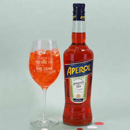Detailansicht des Glases mit Gravur „Perfekter Tag“ und personalisiertem Namen neben einer Flasche Aperol