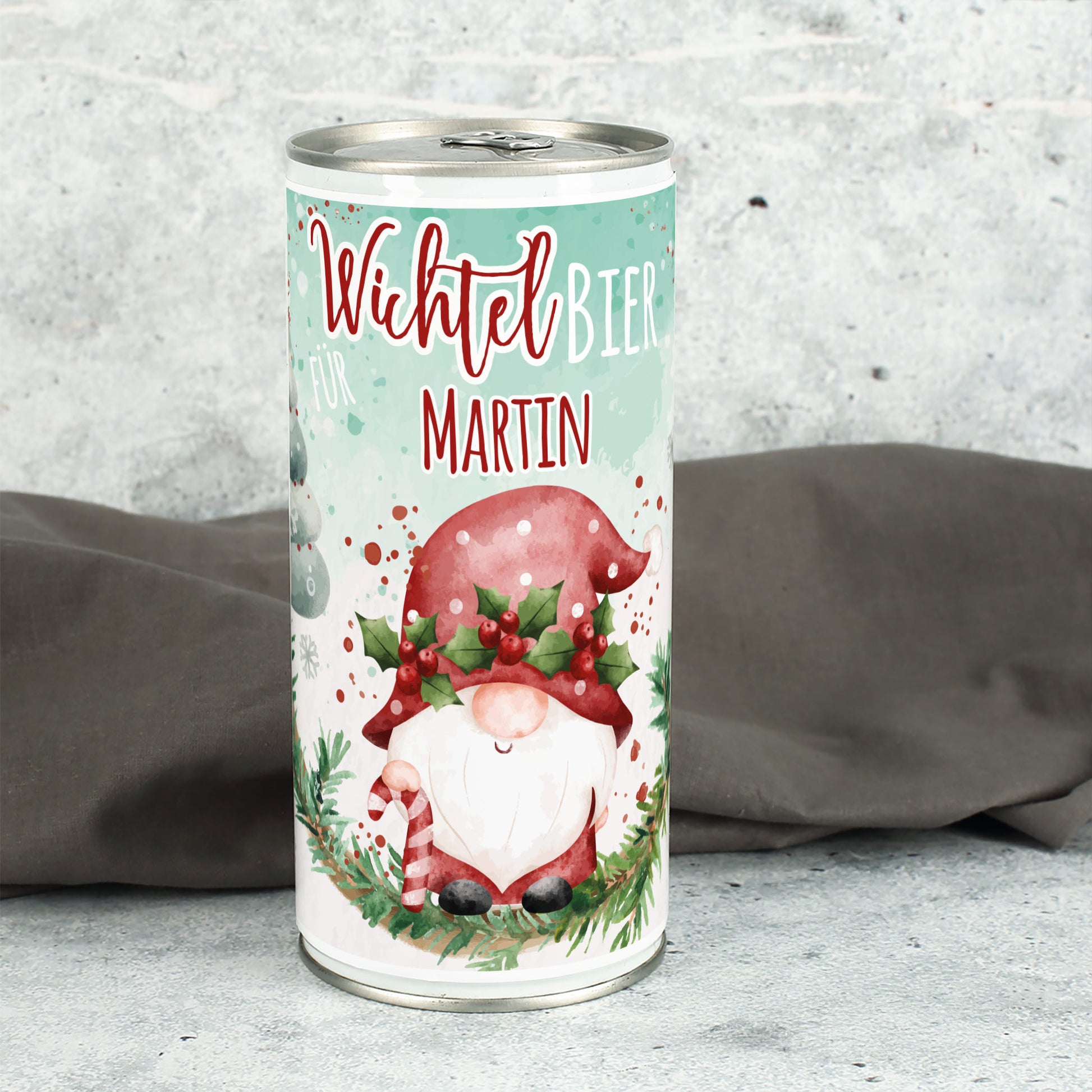 Personalisierte Wichtelbier-Dose mit Name Martin auf grauem Untergrund, mit Wichtelillustration und Tannenzweig.