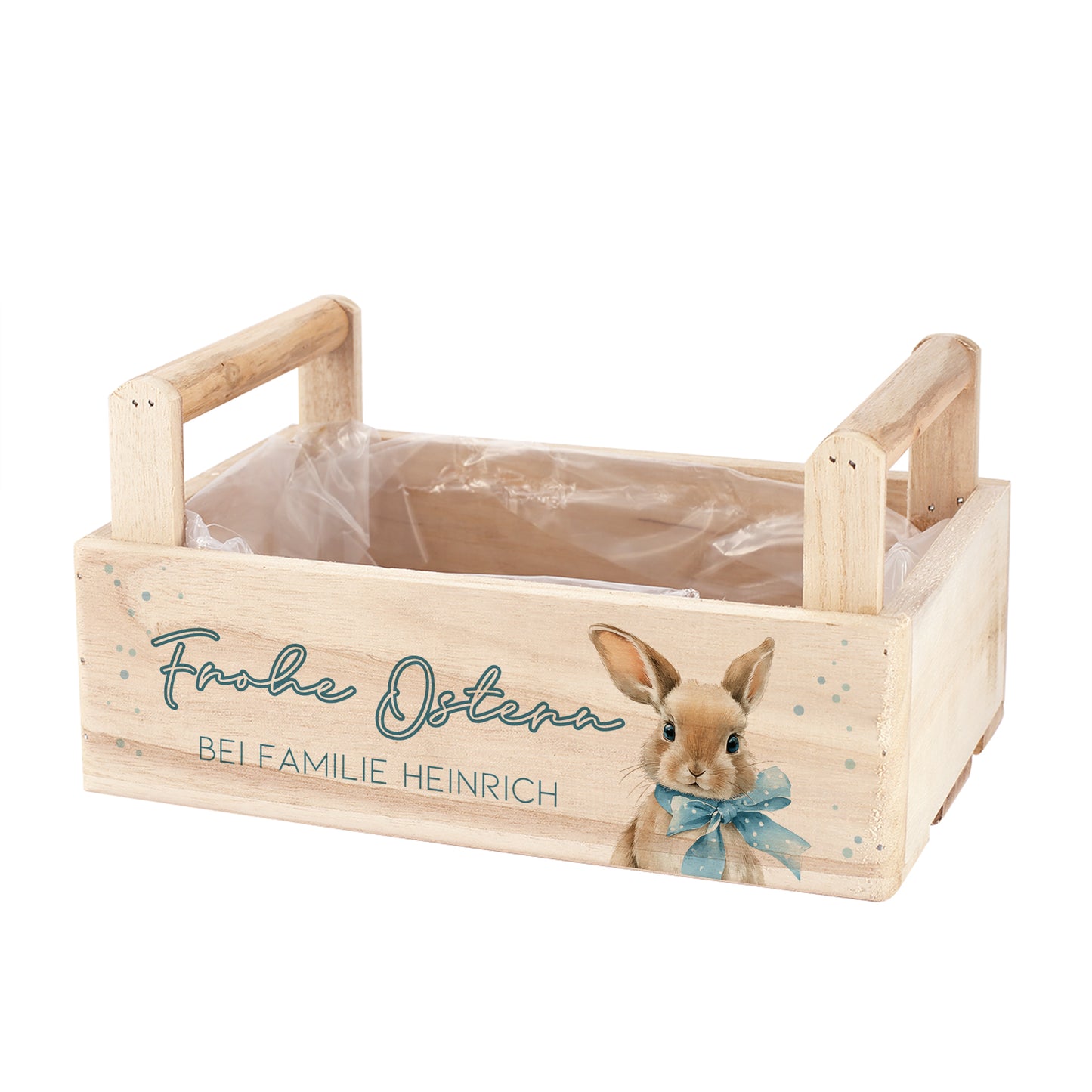 Leere Holzkiste zu Ostern mit zwei seitlichen Griffen, Hasenmotiv, Schriftzug Frohe Ostern und Wunschtext auf der Vorderseite