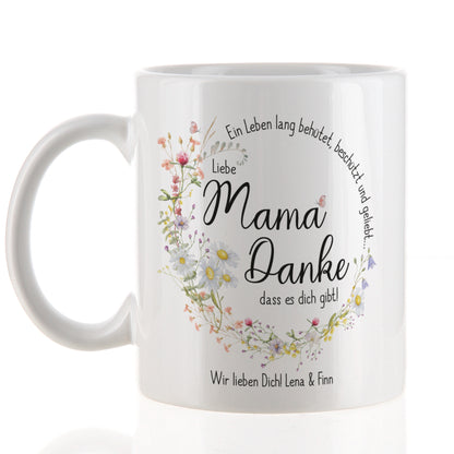 Weiße Keramiktasse mit seidenglänzendem Finish, bedruckt mit einem Kranz aus Wiesenblumen und dem Spruch „Ein Leben lang behütet, beschützt und geliebt…“. In der Mitte steht „Liebe Mama, danke, dass es dich gibt!“, ergänzt durch den Wunschtext „Wir lieben Dich! Lena & Finn“. Die Tasse hat einen klassischen Henkel und ein Fassungsvermögen von 300 ml – perfekt als Geschenk zum Muttertag oder als liebevolles Dankeschön.