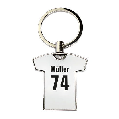 Vorderseite eines weißen Schlüsselanhängers in T-Shirt-Form mit schwarzem Aufdruck