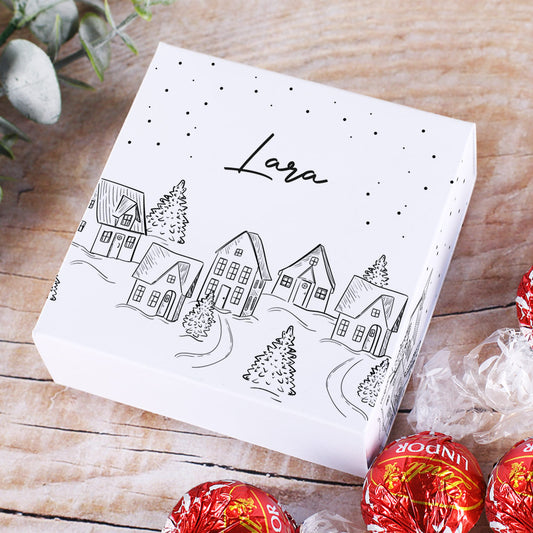 Verpackung für vier Lindor Kugeln mit verschneiter Stadt als Motiv und Ihrem Wunschnamen
