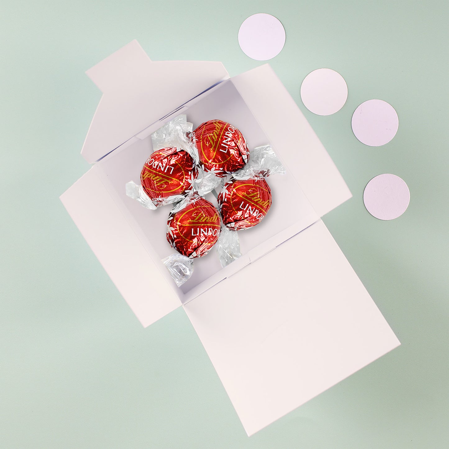 Frohe Ostern Geschenk - 4 Lindorkugeln in pastellfarbener Osterverpackung