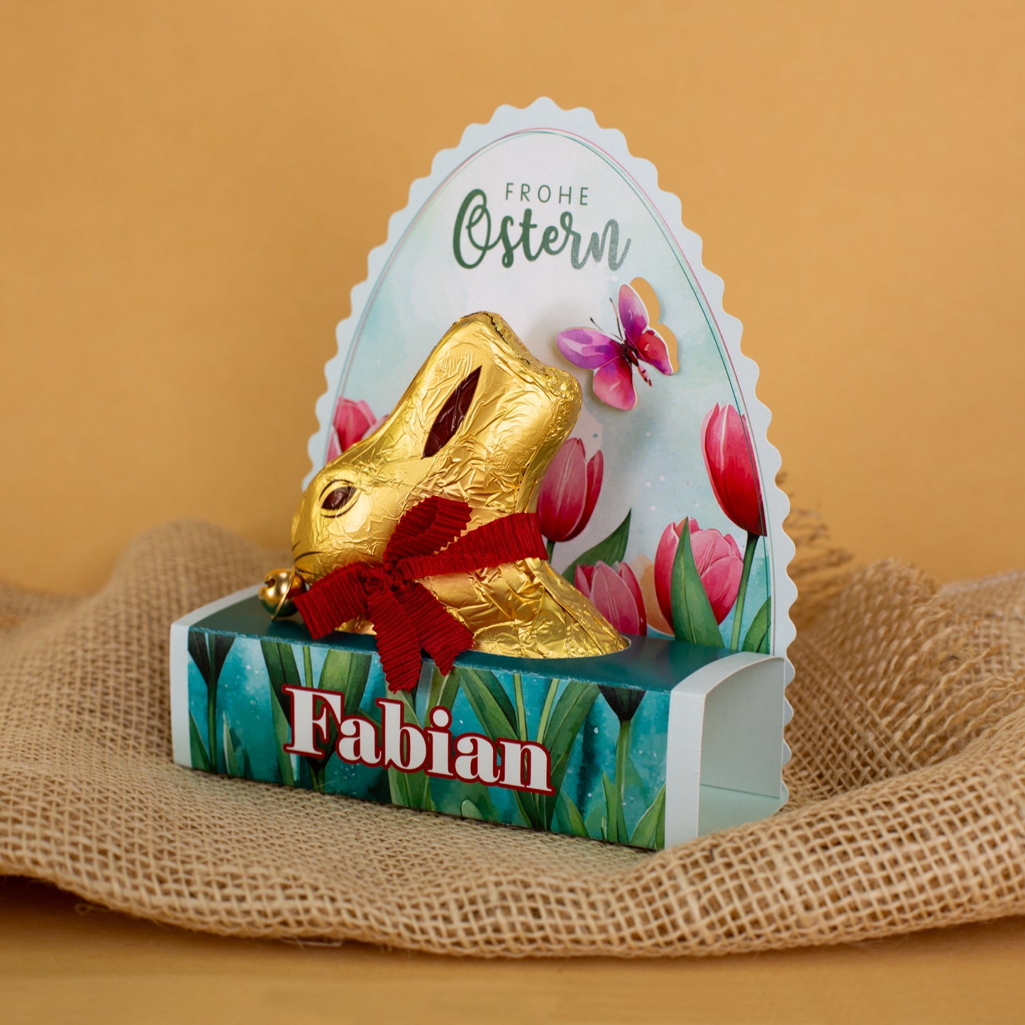 Lindt Goldhase in personalisierter Osterverpackung mit Wunschname "Frohe Ostern"