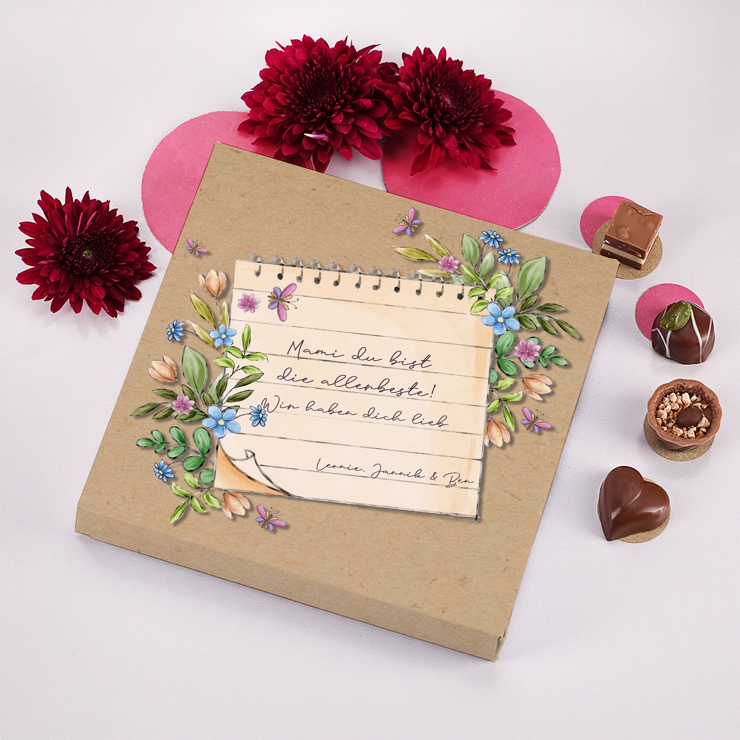 Lindt Pralinen Geschenkbox mit personalisiertem Text und Blumen dekoriert mit Pralinen und Blüten