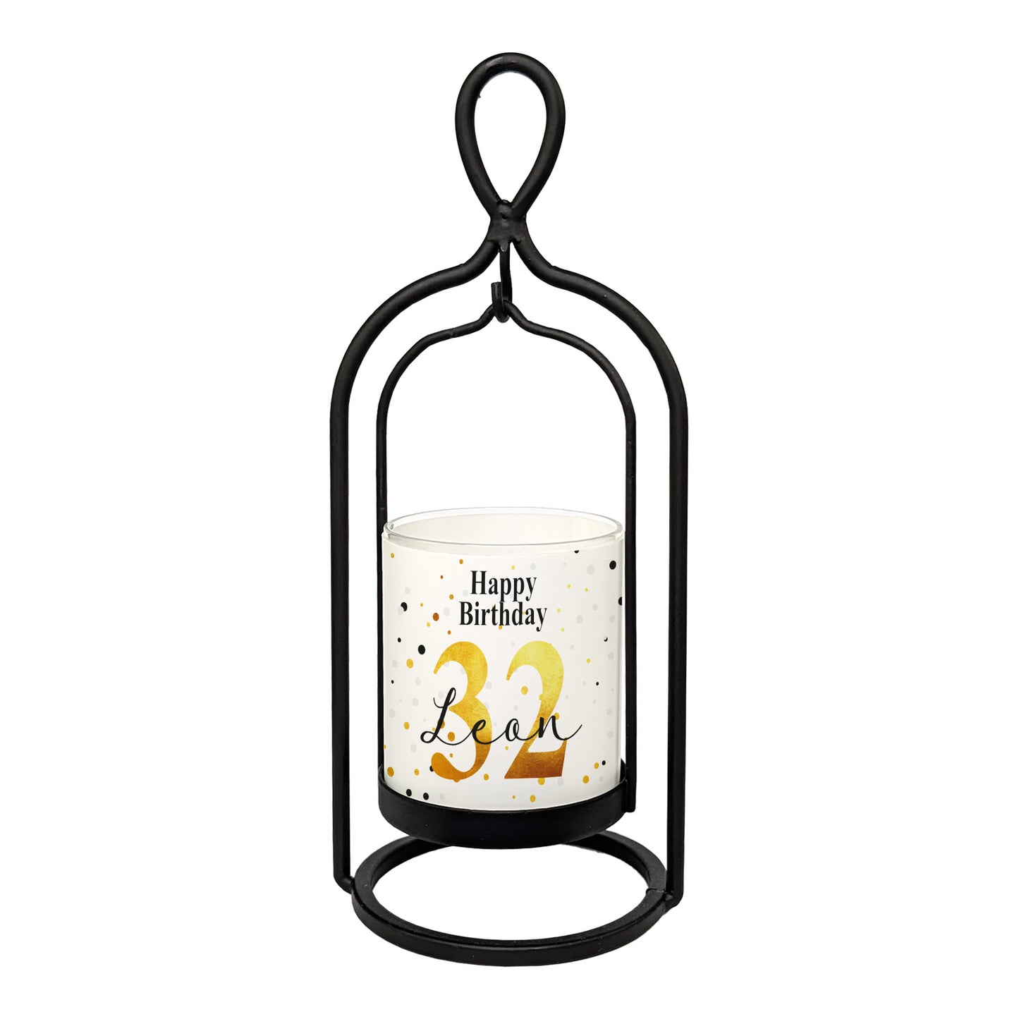 Freigestelltes Produktbild des Windlichts von Ritzenhoff mit weiß-goldener Banderole „Happy Birthday“, personalisiert mit Name und Alter, im schwarzen Metallrahmen – frontal fotografiert auf weißem Hintergrund.