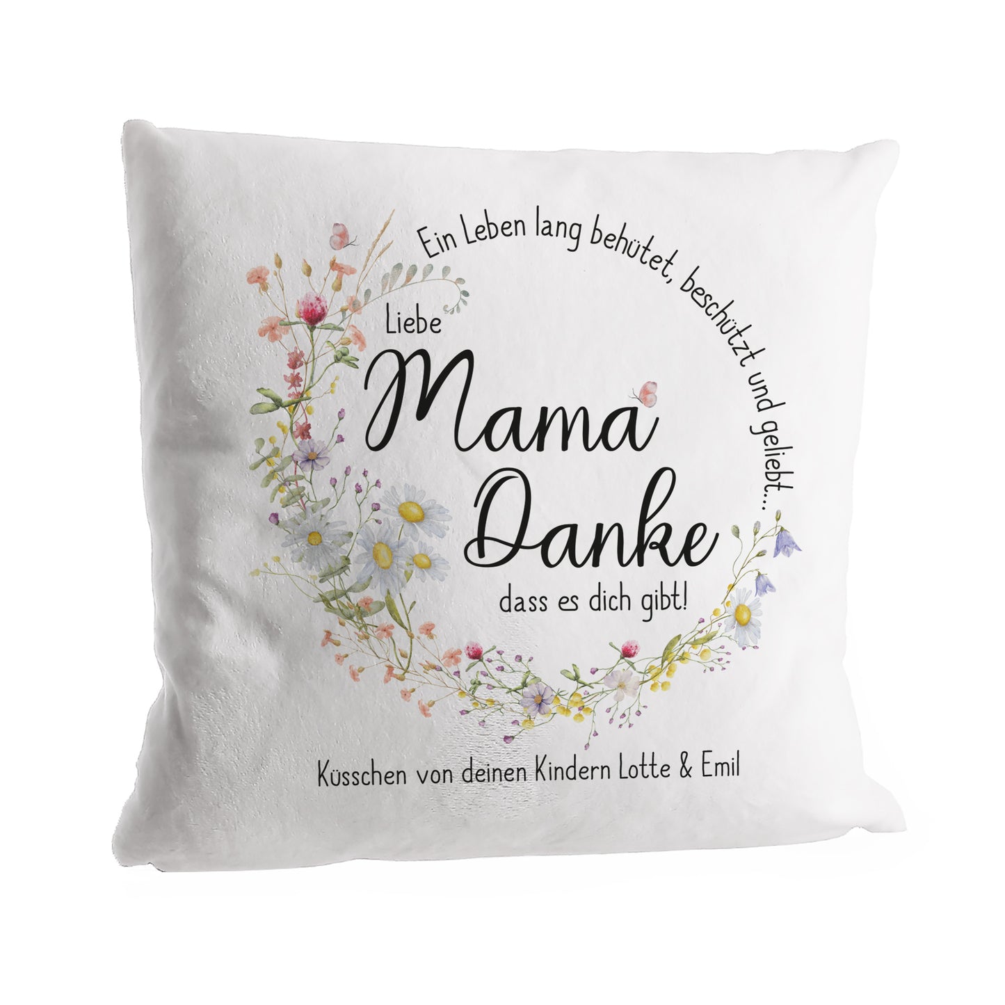Weiches Kuschelkissen mit Muttertags-Aufdruck. Der filigrane Blumenkranz umrahmt den Text „Mama Danke, dass es dich gibt!“, darunter eine persönliche Widmung.