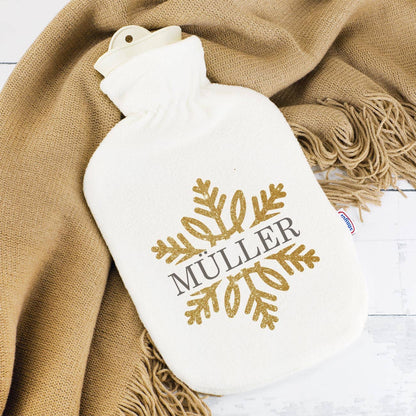 weiße Wärmflasche mit Schneeflocke in Goldoptik und Wunschtext bedruckt